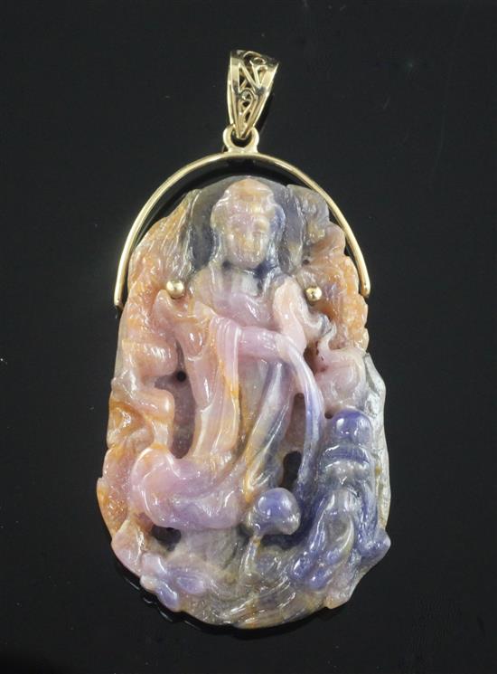 A gold mounted polychrome corundum pendant carved with the figure of Guan Yin, pendant 53mm.